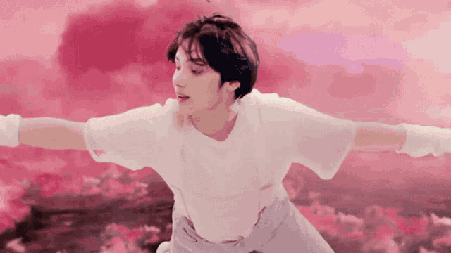 a young man in a white shirt is flying through the air