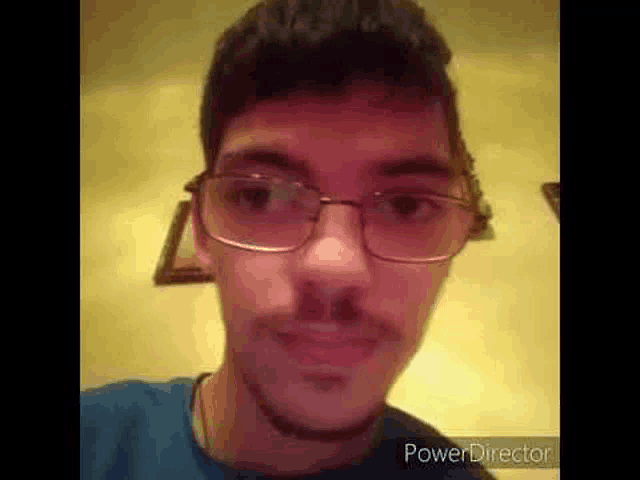 a close up of a man wearing glasses and a beard .