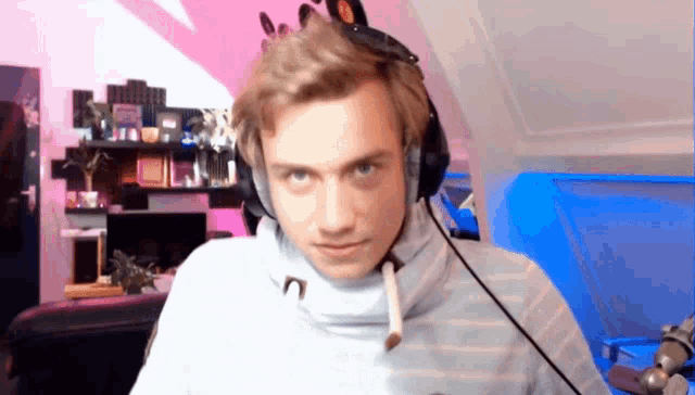 a man wearing headphones and a sweater with the letter n on the neck