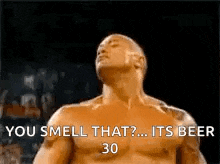 a man without a shirt is standing in front of a crowd and saying `` you smell that ? its beer 30 '' .