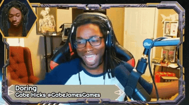 a man wearing headphones and glasses is smiling in front of a microphone and says doring gabe hicks @gabejames games