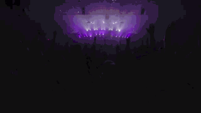 a silhouette of a person raising their hand in the air