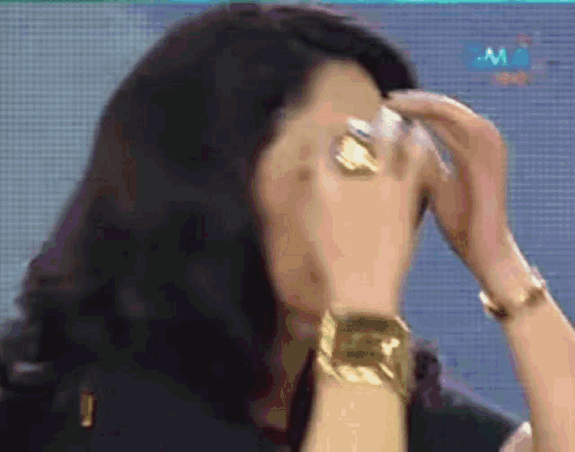 a woman with a ring on her finger is covering her face with her hand .