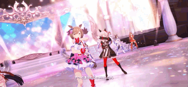 a group of anime girls are dancing on a stage with chinese writing on the bottom right