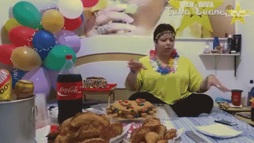 a woman is sitting at a table with a coca cola bottle