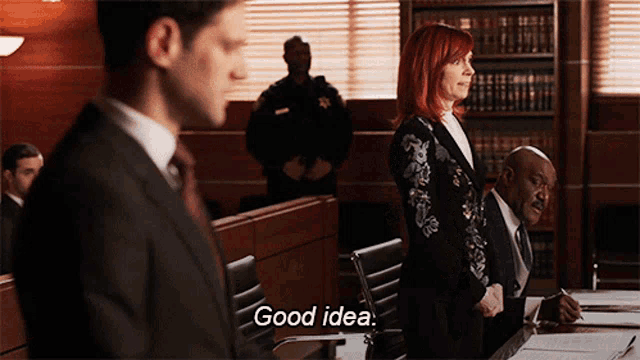 a man in a suit and tie stands next to a woman in a suit who says good idea