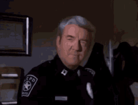 a man in a police uniform has the name richard herd on the screen
