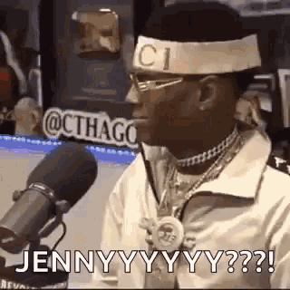 a man wearing a headband with the word gucci on it is talking into a microphone .