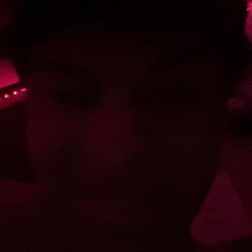 a close up of a person 's face in a dark room