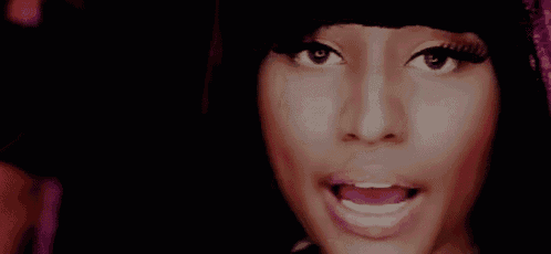 a close up of a woman 's face with a surprised expression .