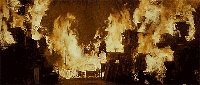 a building is on fire with a sign that says ' ambulance ' in the background