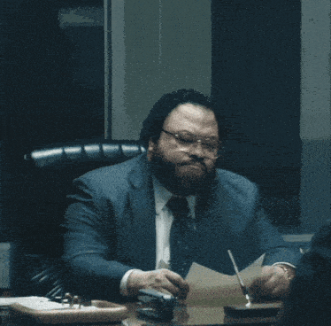 a man in a suit and tie is sitting at a desk with the words if you could be any kind of door what would