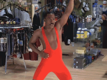 a man in a red leotard stands in front of a store