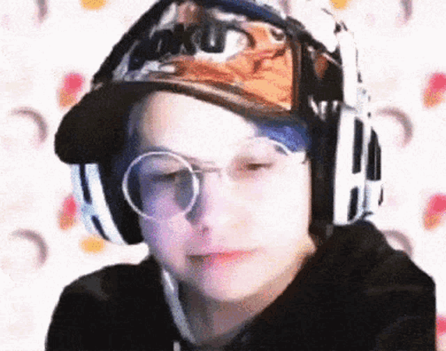 a person wearing headphones and a hat that says ' tokyo ' on it
