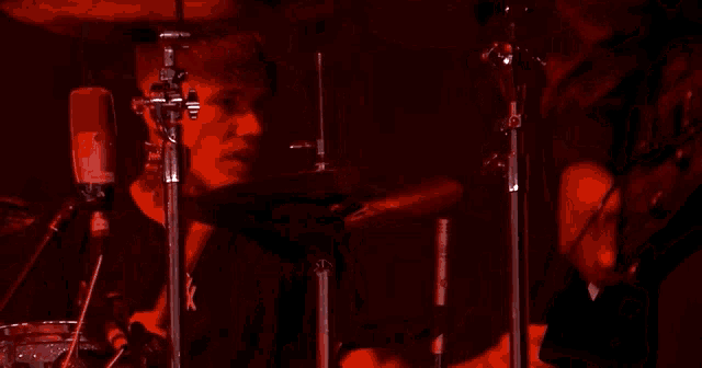 a man is playing a drum set with a roland drum pad
