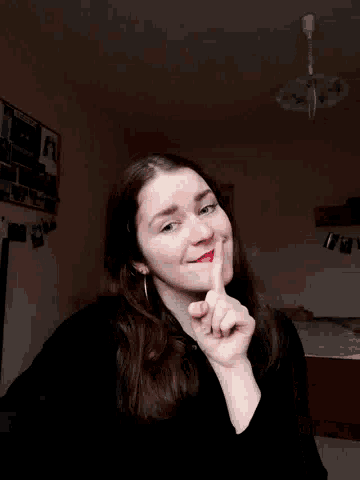 a woman with red lipstick on her lips is smiling and making a funny face