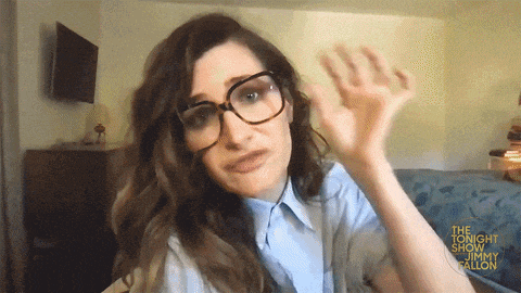 a woman wearing glasses and a blue shirt says jimmy fallon