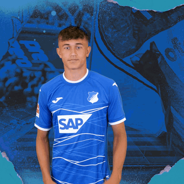 a young man wearing a blue shirt with the word sap on it
