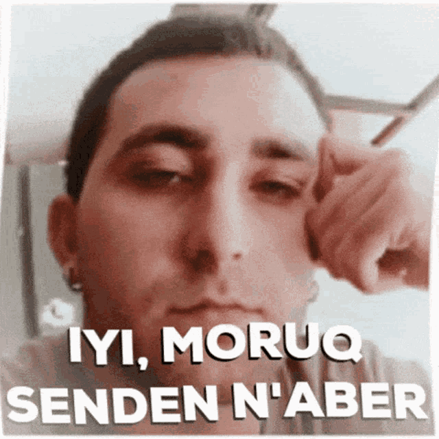a man with his eyes closed has the words iyi moruq senden n'aber written above him