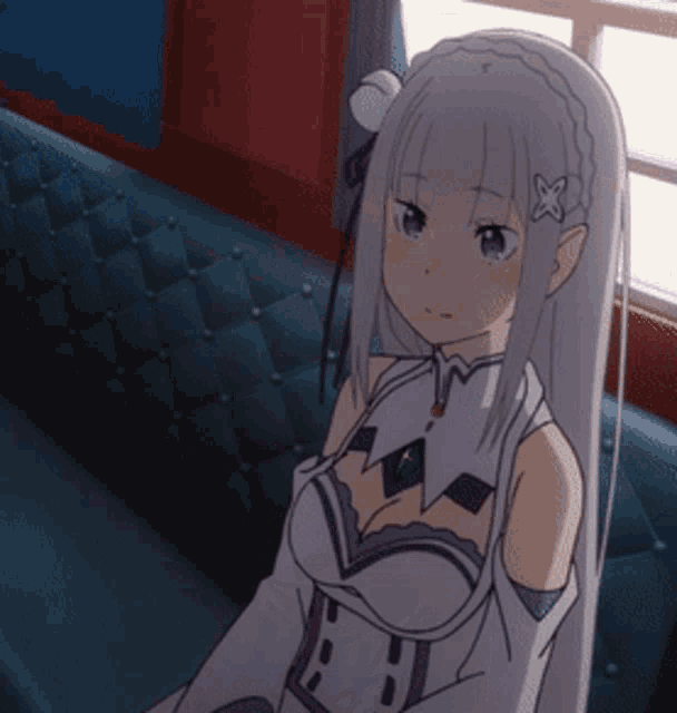 a girl with white hair and purple eyes is sitting on a couch