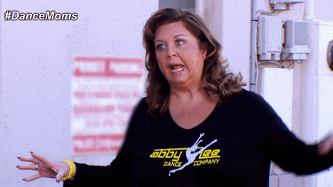 a woman wearing a black shirt with abby lee dance company on it