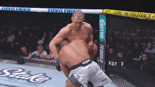 two men are fighting in a boxing ring sponsored by toyo tires and corona tequila