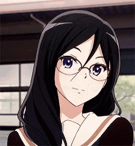 a girl with long black hair and glasses is looking at the camera .