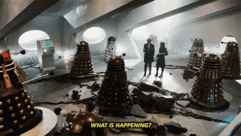 a group of dalek robots are standing in a room with the words " what is happening " on the bottom
