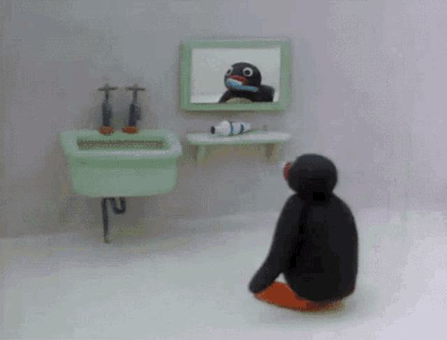 a penguin is brushing its teeth in front of a mirror