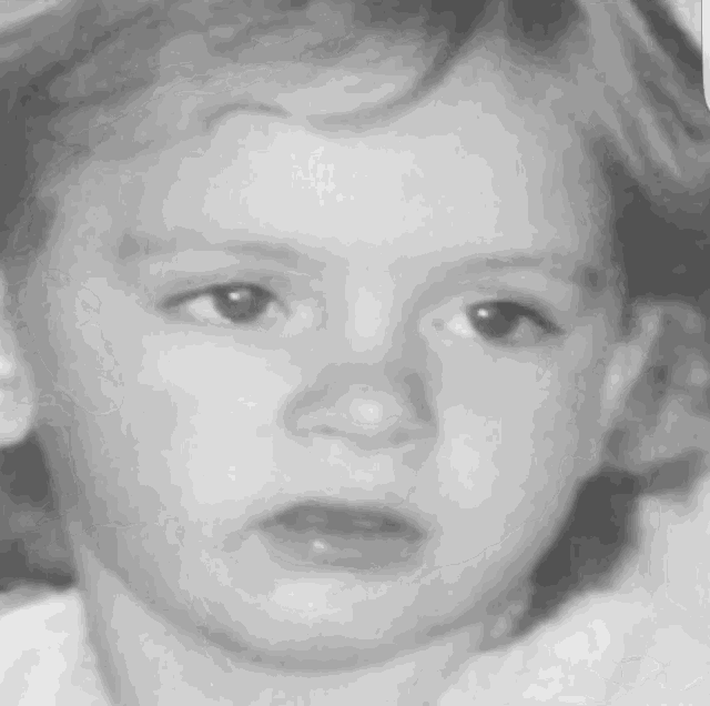 a close up of a child 's face with a serious look on his face