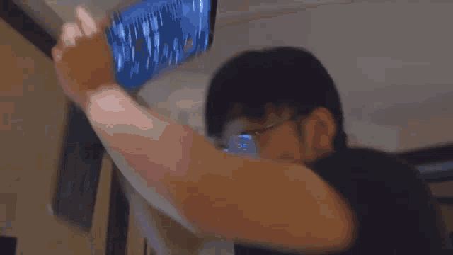 a blurry picture of a man using a laptop computer
