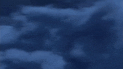 a plane is flying through a cloudy sky