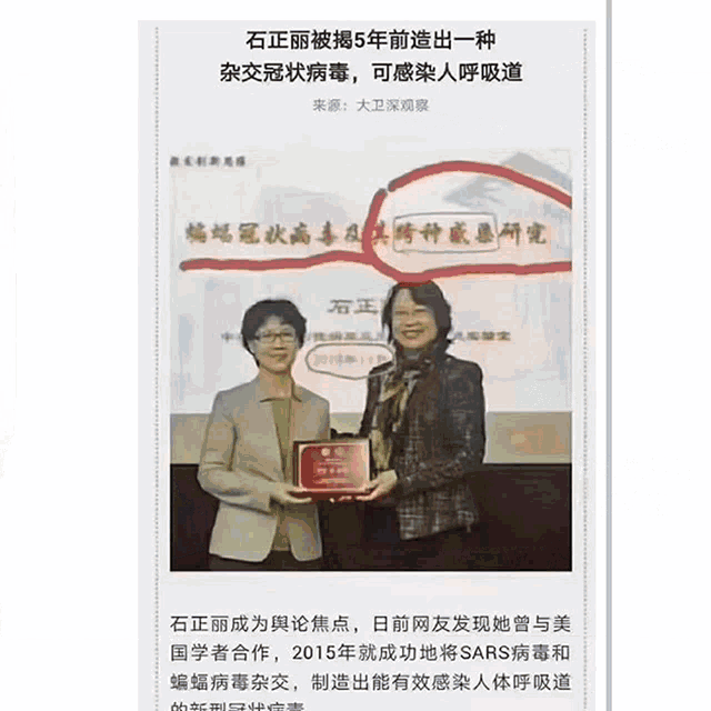 two women standing next to each other holding a certificate in a foreign language