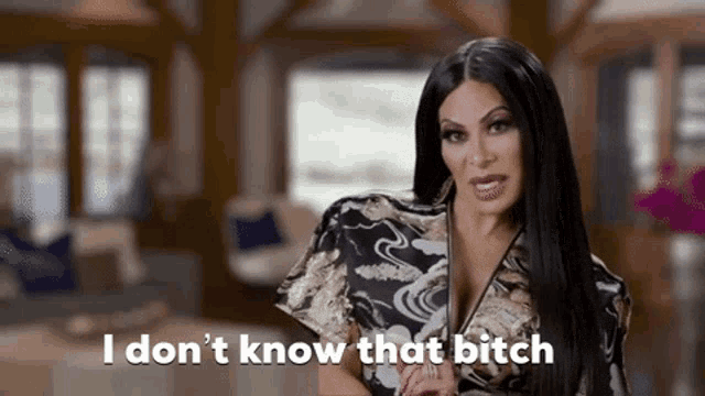 a woman is standing in a living room and saying `` i don 't know that bitch ''
