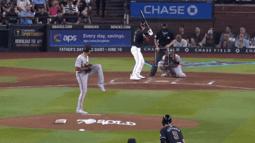 a baseball game is being played in front of a chase bank banner