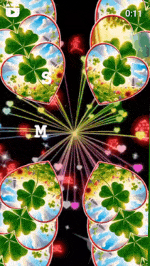 a screen with hearts and clovers and the letter m
