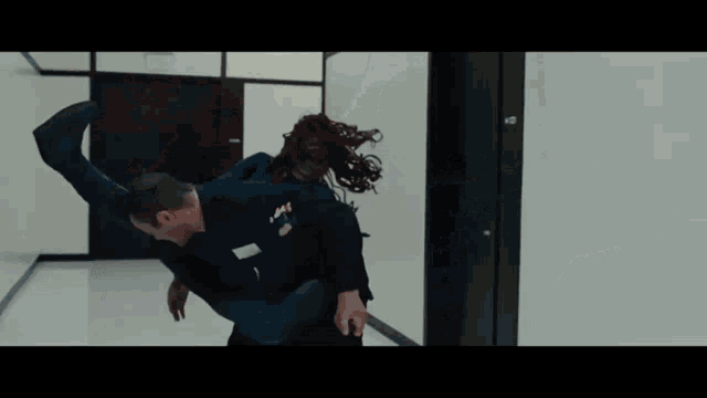 a woman with red hair is being held by a man