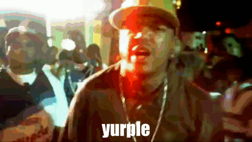 a blurry picture of a man singing with the word yurlple in the corner
