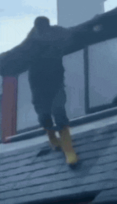 a man is jumping over a fence in a blurry photo