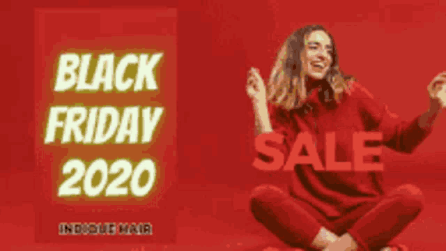a woman is sitting on the floor in front of a black friday sale sign