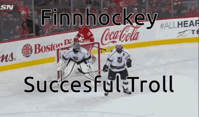 a hockey game is being played in front of a coca cola advertisement