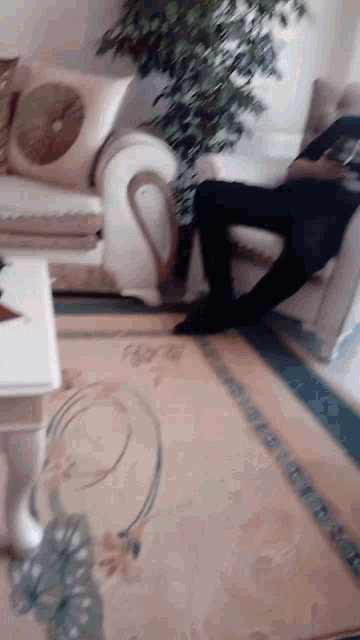 a man sitting in a chair in a living room