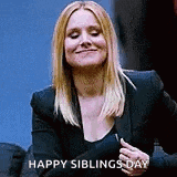 a woman in a black jacket is smiling and holding her hand to her chest while saying happy siblings day .