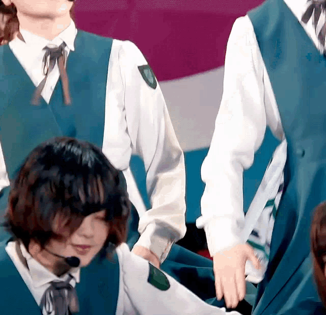 a girl with a microphone on her head is standing next to another girl