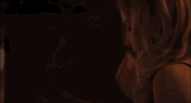 a man and a woman are looking at each other in the dark .