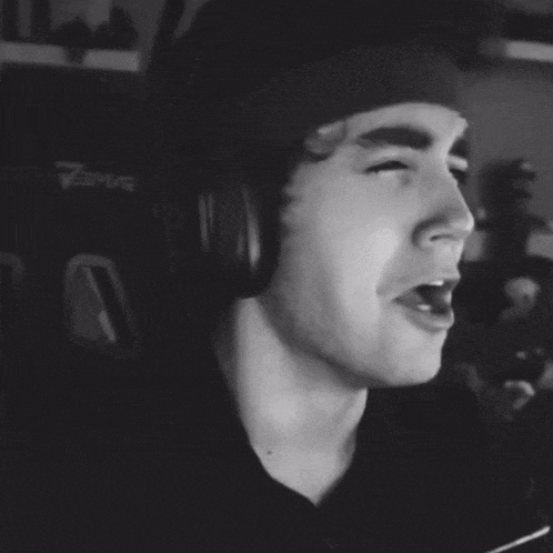 a black and white photo of a man wearing headphones and a beanie that says 7sma