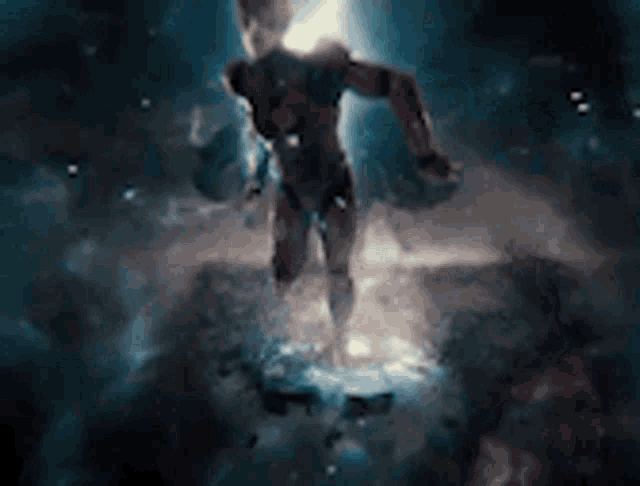 a superhero is flying through the air in a dark space .