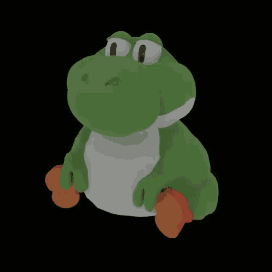 a stuffed toy of a green dinosaur with orange shoes