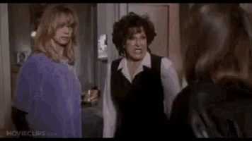 a group of women are standing next to each other in a room in a movie .