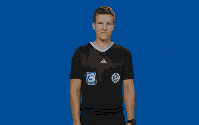 a man wearing a black adidas shirt has his arms outstretched in front of a blue background